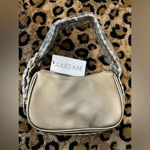 New Jules Kae women's Delilah hand bag in gold. Retails for $130.00.